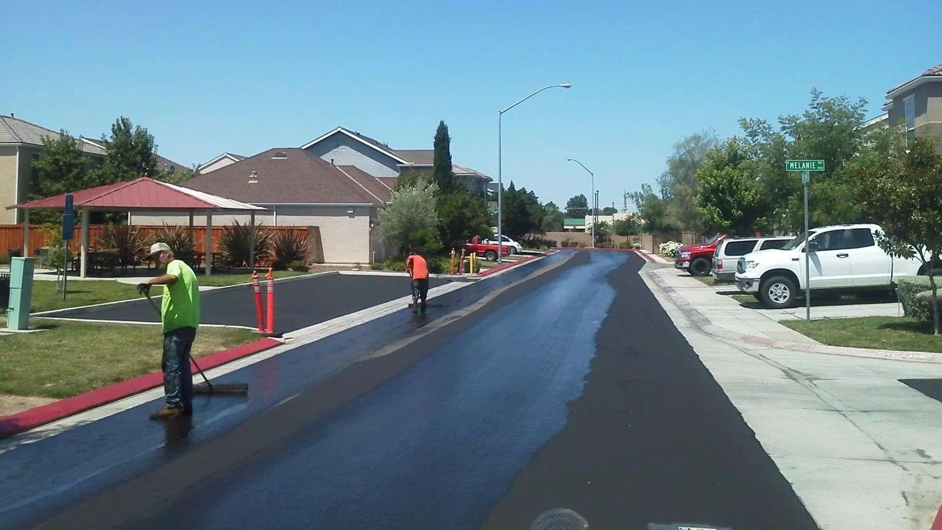The California Asphalt Professionals crew paving a fresh asphalt residential street in the Central Valley.