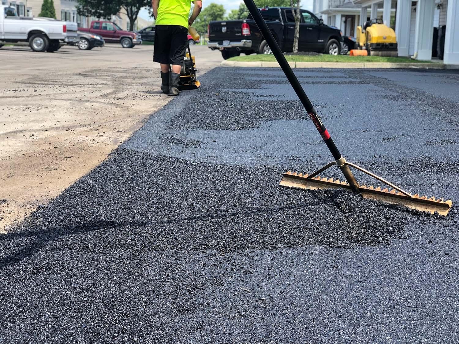 Crew luting a hot asphalt patch.