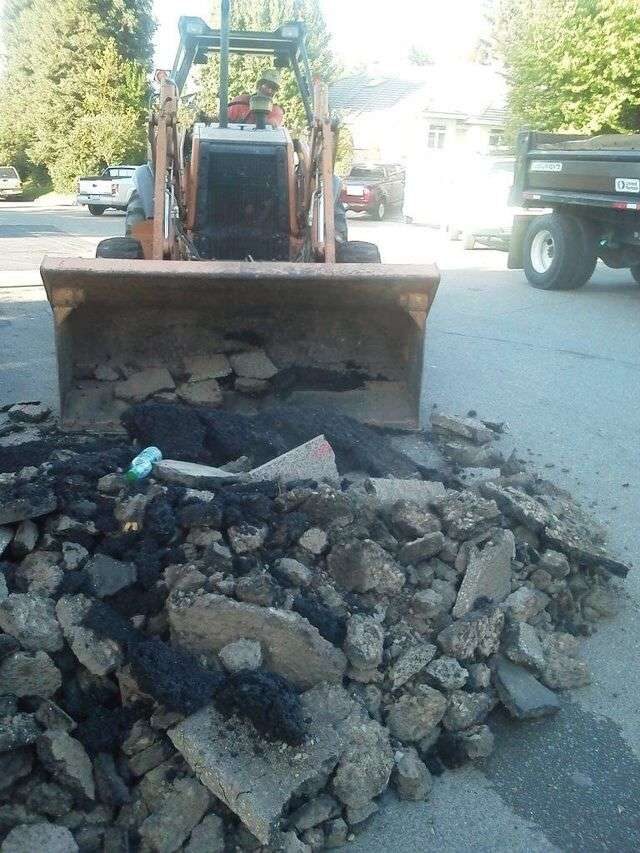 Cutting out failed asphalt before a hot patch.